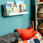 red textile on blue and white bed linen