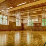 brown wooden parquet floor with white wall